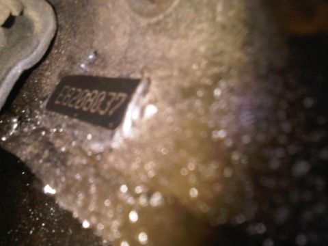 1985 Ford Bronco - VIN plate with identification number E8208037 is visible on a dirty surface.