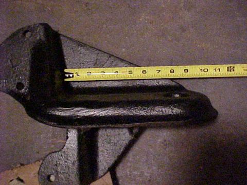 1995 Ford Bronco - A black metal part is shown with a yellow tape measure indicating a length of approximately 5 inches.