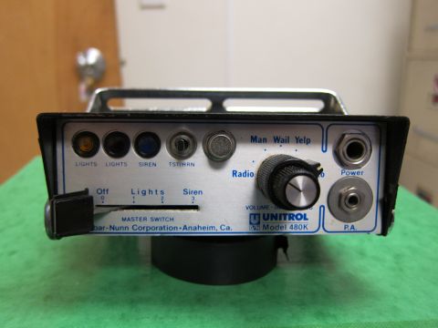 2001 Ford Crown Victoria - This Unitrol Model 480K control unit features switches for lights, siren, and radio, along with volume control and power/PA jacks.