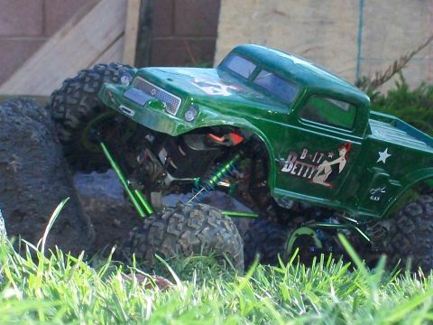 1985 Ford Bronco - This remote control truck navigates a rocky terrain with its large off-road tires and detailed body.