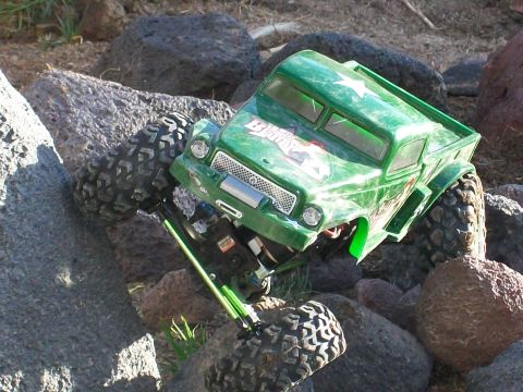 1985 Ford Bronco - This green remote control truck navigates a rocky terrain.