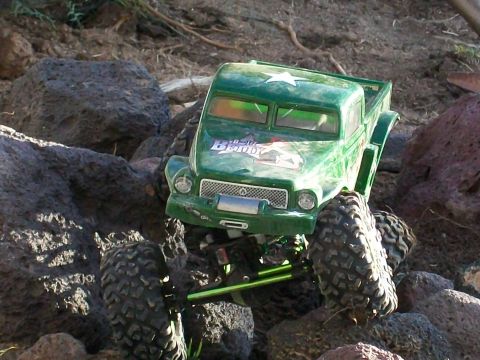 1985 Ford Bronco - This remote-controlled truck is navigating a rocky terrain.