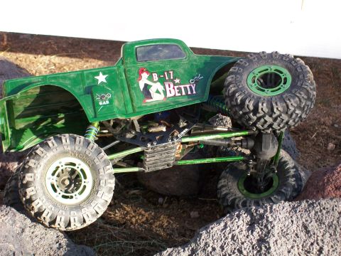 1985 Ford Bronco - This green RC rock crawler truck features large off-road tires and custom graphics.