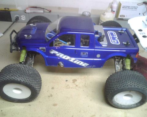 1985 Ford Bronco - This blue remote control monster truck features large tires and Pro-Line branding on its body.