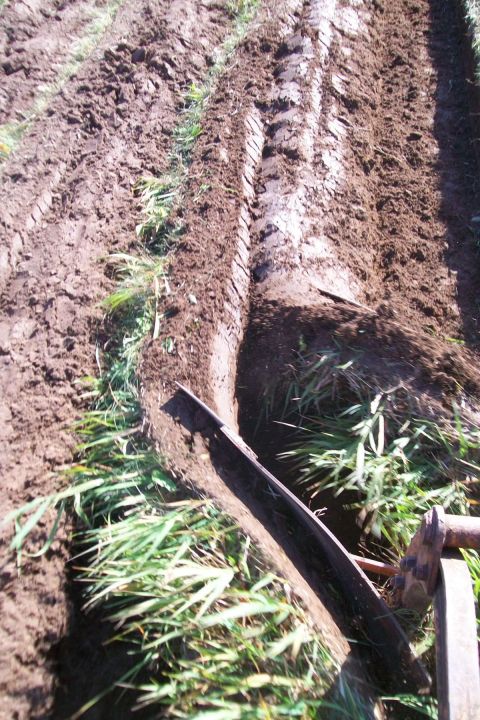 2000 Chevrolet Tahoe - Tire tracks mark the path through a freshly plowed field.