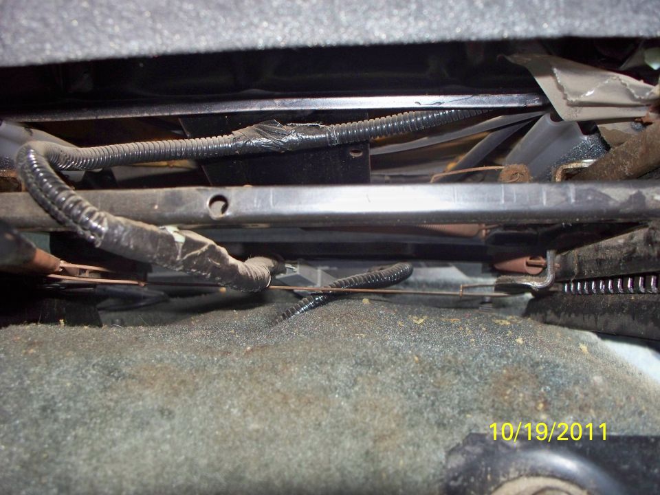 Underneath car seat wiring harness and metal frame