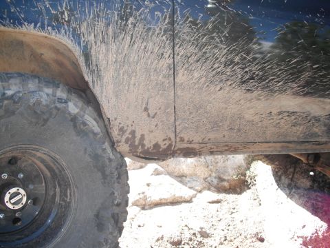 1991 Ford Bronco - This 1991 Ford Bronco shows off its off-road capabilities with extensive mud splatter on its side panel.