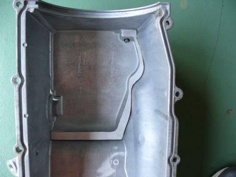 1976 Chevrolet Corvette - This is a close-up view of the interior of a vehicle's oil pan, showing its internal baffle structure.