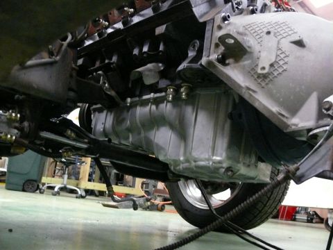 1976 Chevrolet Corvette - Underside view of an engine's oil pan and transmission assembly, with a wheel visible.