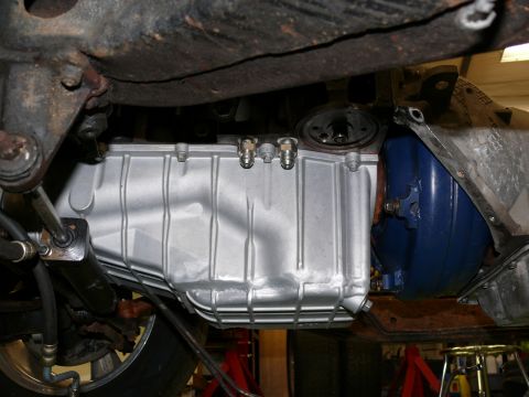 1976 Chevrolet Corvette - Close-up of the oil pan and transmission assembly on a vehicle's underside.
