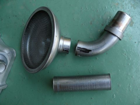 1976 Chevrolet Corvette - This image shows an exhaust pipe and an air intake component, with the Supermotors.net logo visible in the lower right corner.