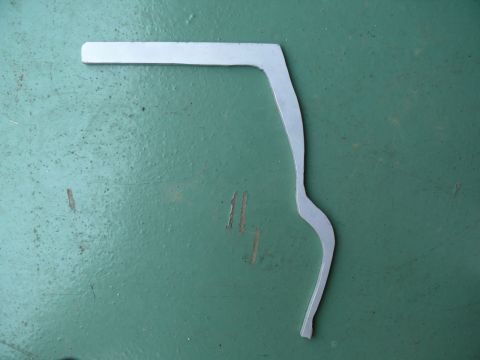 1976 Chevrolet Corvette - A metal bracket is shown against a textured green background.