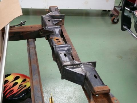 1976 Chevrolet Corvette - A section of a Corvette frame is shown, with a flame-decorated object visible in the lower left.