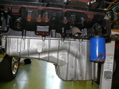 1976 Chevrolet Corvette - Engine oil pan and filter assembly, with a tire visible in the background.