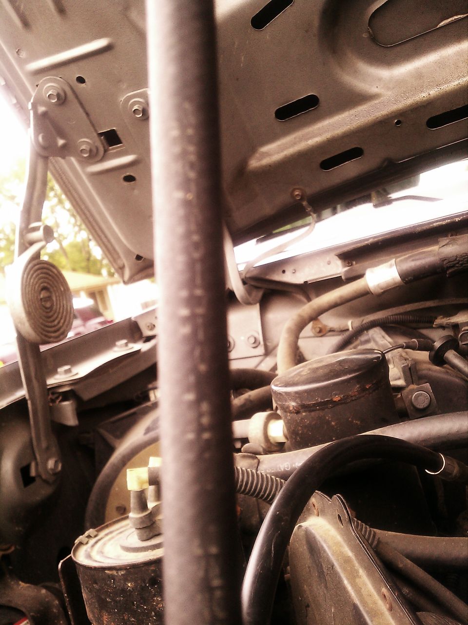 1987 Ford F-150 engine bay, hood open, showing hoses and engine components