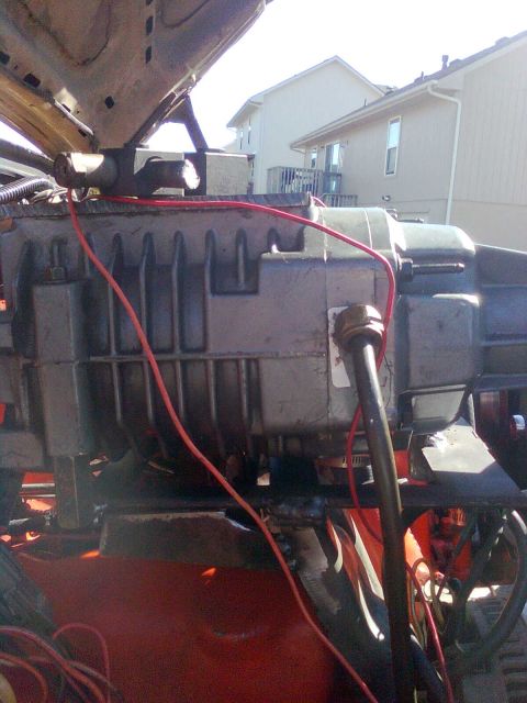 1984 Ford Bronco - Close-up view of a supercharger installation in a vehicle's engine bay.
