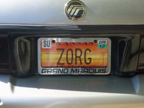 2000 Mercury Grand Marquis - The license plate frame reads 'GRAND MARQUIS' and the plate itself has a sunset graphic.