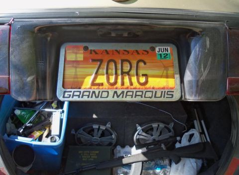 2000 Mercury Grand Marquis - Trunk contents include a license plate frame that reads 'GRAND MARQUIS'.