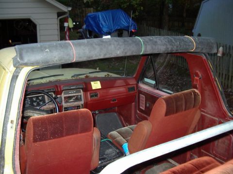 1985 Ford Bronco - Rubber top neatly rolled up and held in place with miniature bungy cords.