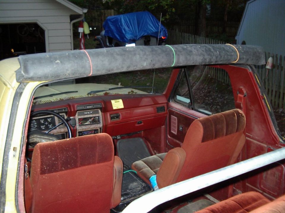 Rubber top neatly rolled up and held in place with miniature bungy cords.