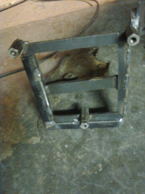 1984 Ford Bronco - Custom fabricated metal bracket shown on a workshop floor.