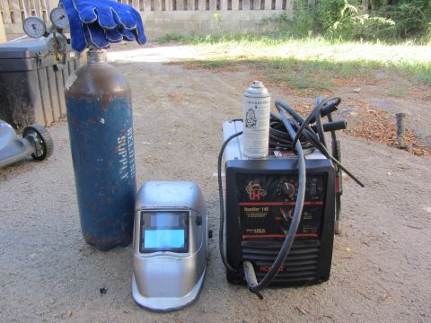 1968 Ford Mustang - Welding equipment including a helmet, gas cylinder, and a Hobart Handler 140 welder is set up outdoors.