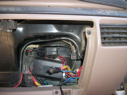 1996 Ford Bronco - The interior of a vehicle with the dash panel removed, revealing electrical wiring and components.
