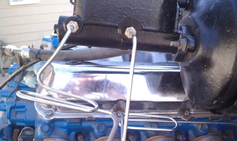 1979 Ford Bronco - This image shows a close-up view of engine components, specifically a brake master cylinder and associated lines.
