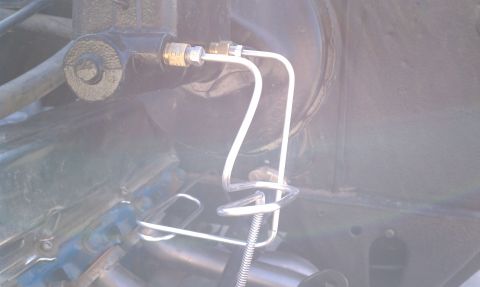 1979 Ford Bronco - Close-up view of a vehicle's brake system components, including the master cylinder and brake lines.
