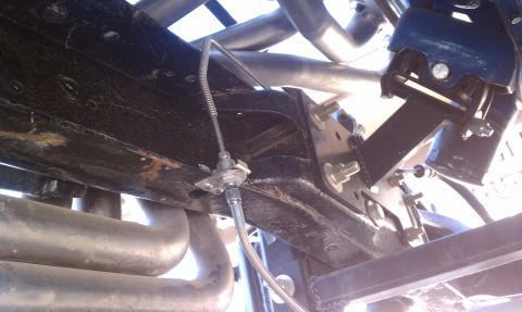 1979 Ford Bronco - Close-up view of the undercarriage, focusing on brake lines and exhaust components.