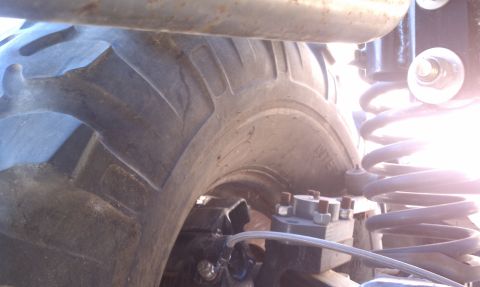 1979 Ford Bronco - Detail shot of a vehicle's tire and suspension system, focusing on mechanical components.