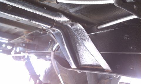 1979 Ford Bronco - Close-up view of the undercarriage, focusing on frame and brake line components.