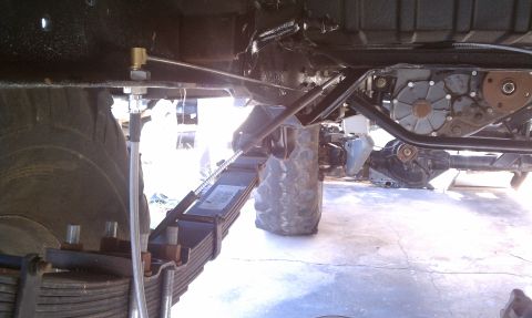 1979 Ford Bronco - Undercarriage detail showing leaf springs and transfer case, with visible text on the leaf spring.