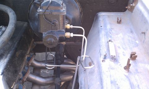 1979 Ford Bronco - Close-up view of a brake master cylinder and associated brake lines.