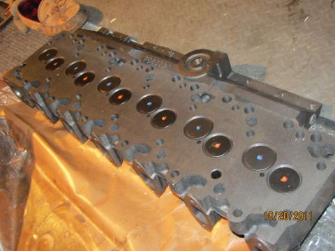1984 Ford Bronco - A close-up view of an engine cylinder head, showing its internal components and ports.