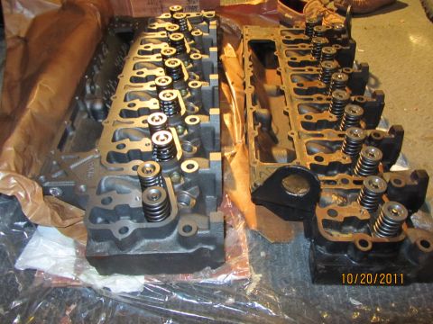 1984 Ford Bronco - Two engine cylinder heads are shown side-by-side, with valve springs installed.