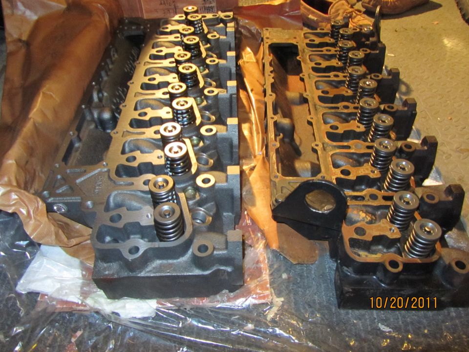 Two engine cylinder heads with valve springs visible