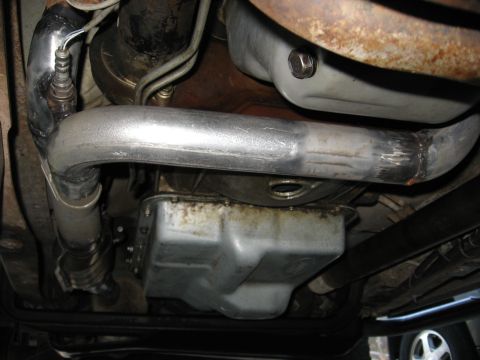 1994 Ford Bronco - Underside view of an exhaust pipe and oil pan, with visible text from Supermotors.net.