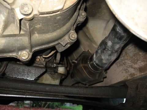 1994 Ford Bronco - Close-up of a vehicle's exhaust system, showing the catalytic converter and pipework.