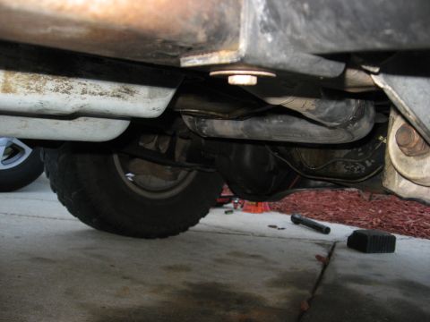 1994 Ford Bronco - Close-up of vehicle undercarriage, focusing on exhaust and suspension parts.