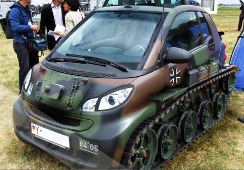 2000 Mercury Grand Marquis - This Smart car has been modified with tank treads and a camouflage paint scheme, a German cross emblem on the side.