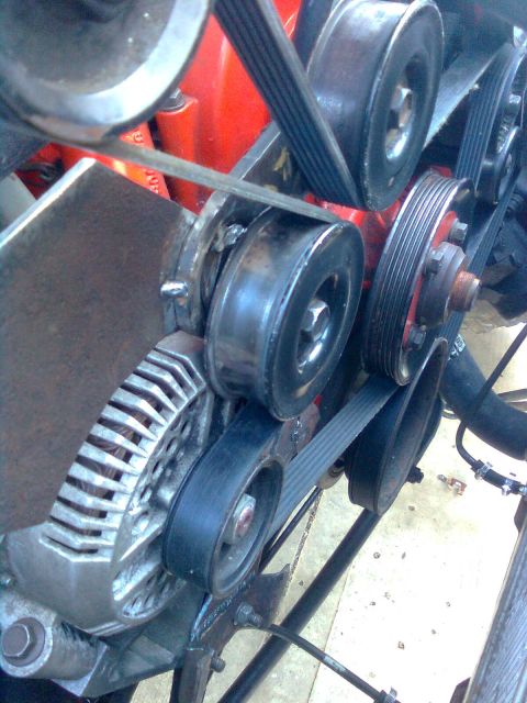 1984 Ford Bronco - Close-up view of the engine bay, focusing on the arrangement of belts and pulleys.