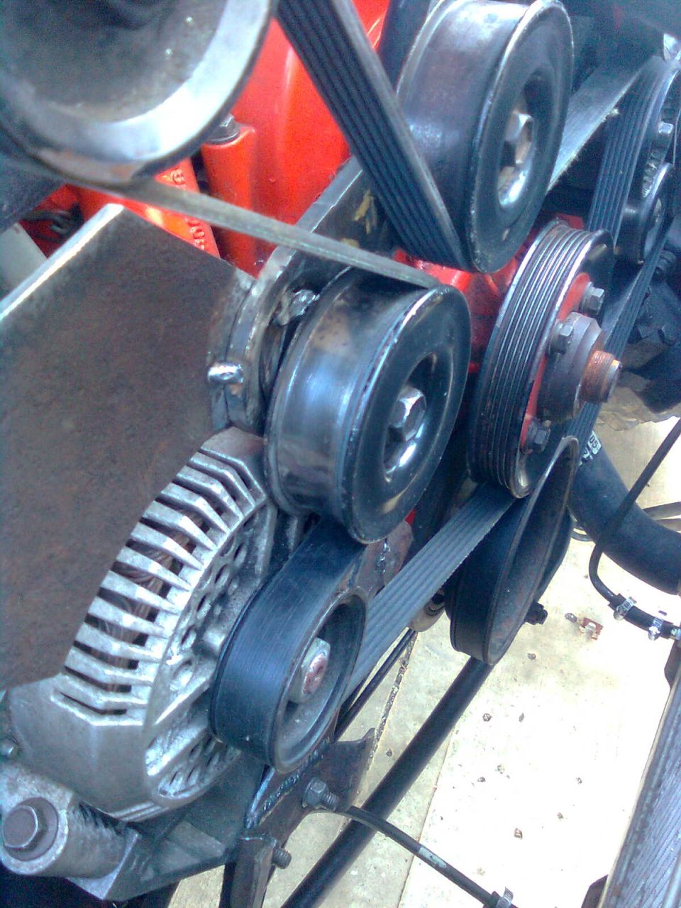 Engine bay with serpentine belts and pulleys