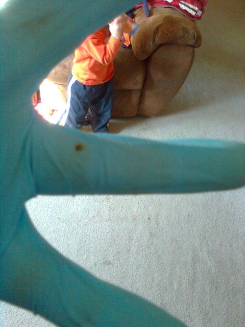 1984 Ford Bronco - Child playing with a toy near a recliner in a carpeted room.