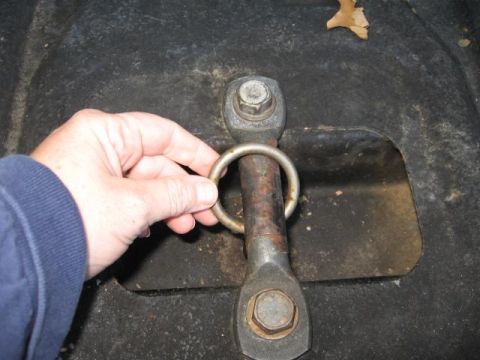 1978 Ford Bronco - Close-up of a tie-down ring being held by a hand.