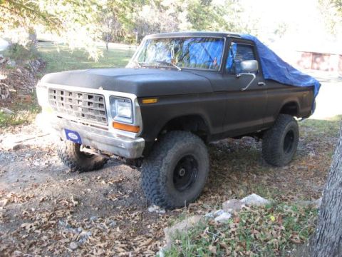 1978 Ford Bronco - This 1978 Ford Bronco is seen from a three-quarter front angle, partially covered by a blue tarp.