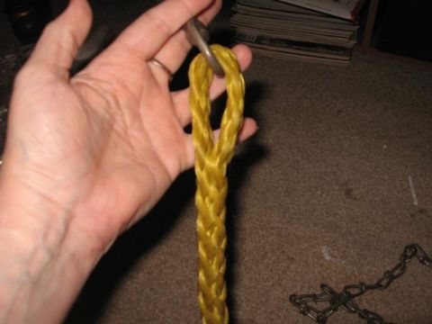 1978 Ford Bronco - A hand holds a yellow rope with a metal ring, against a carpeted background.