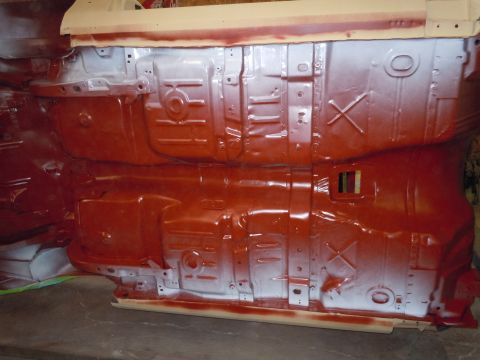 1973 Pontiac Trans Am - The underside of a vehicle is shown with fresh red and white paint applied during restoration.