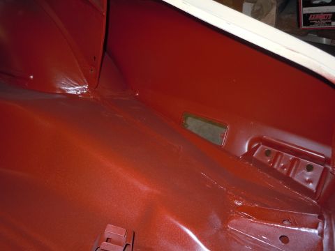 1973 Pontiac Trans Am - Close-up of a car's interior, revealing painted metal surfaces and structural details.