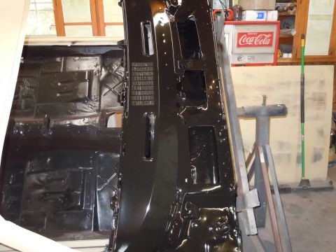 1973 Pontiac Trans Am - Underside of a car's floor pan and transmission tunnel, coated in black paint.